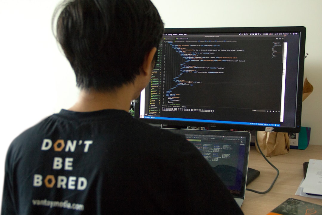 【Claude Code】CLI連携でAI開発を加速！実践的活用術【2025年最新】 - man in black shirt using laptop computer and flat screen monitor