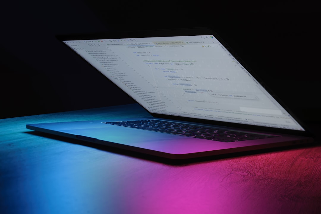 【Claude Code】2.0.58リリース！Opus 4.5搭載で開発力UP【2025年最新】 - Open laptop with code on screen, neon lighting