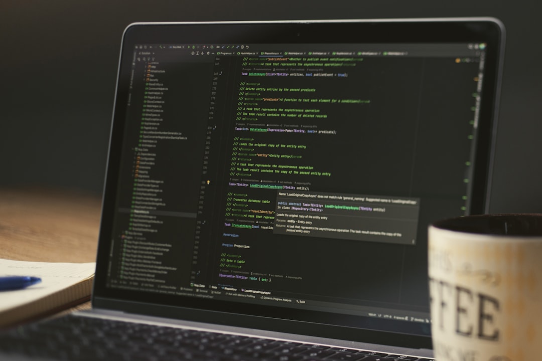 【Cursor】マーケットプレイス登場！AI開発を加速する新機能を徹底解説 - Laptop screen displaying lines of code with a coffee mug.